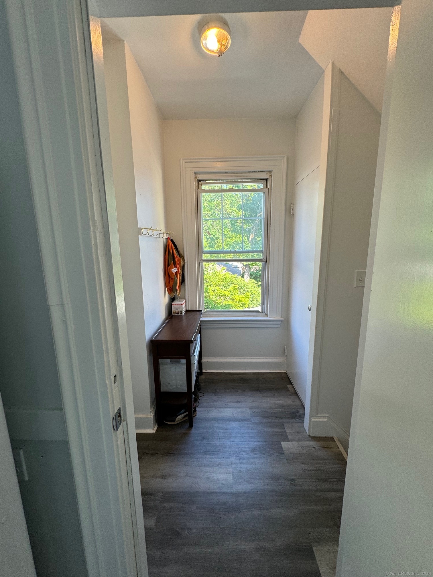 1253 Forest Road, Unit 2 New Haven, CT 06515 - Photo 28 of 30 a view of a room with a window and wooden floor