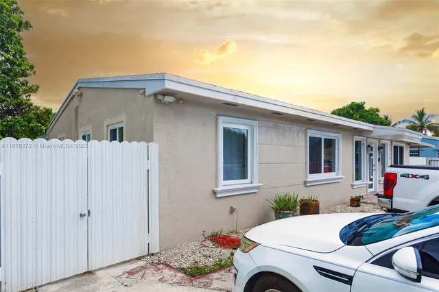 a view of backyard with a table and chairs
