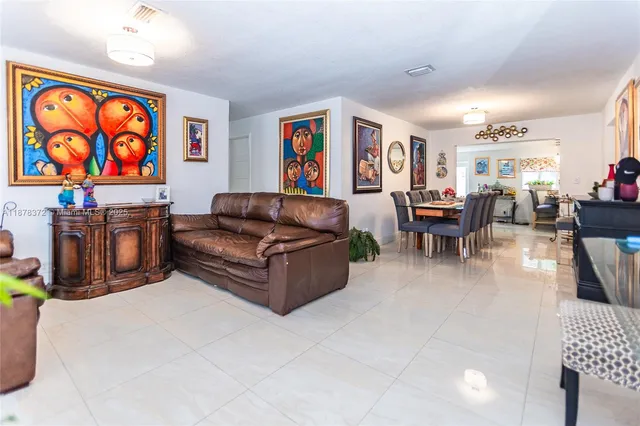 a living room with furniture a couch and a flat screen tv
