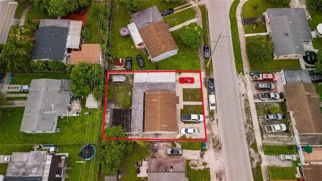 an aerial view of multiple houses with yard