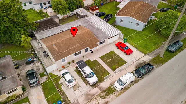 an aerial view of a houses with yard
