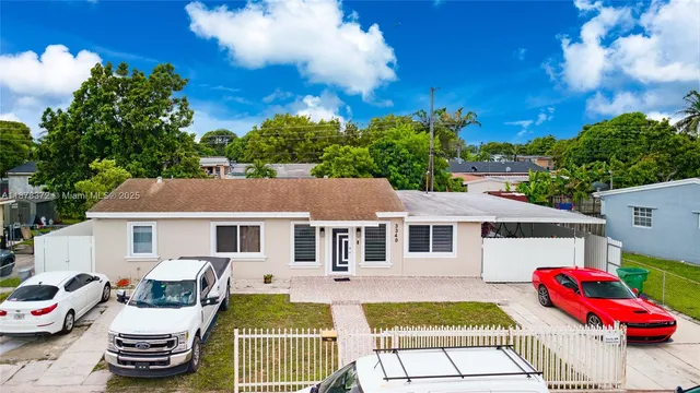 a view of a white house with a swimming pool and a chairs