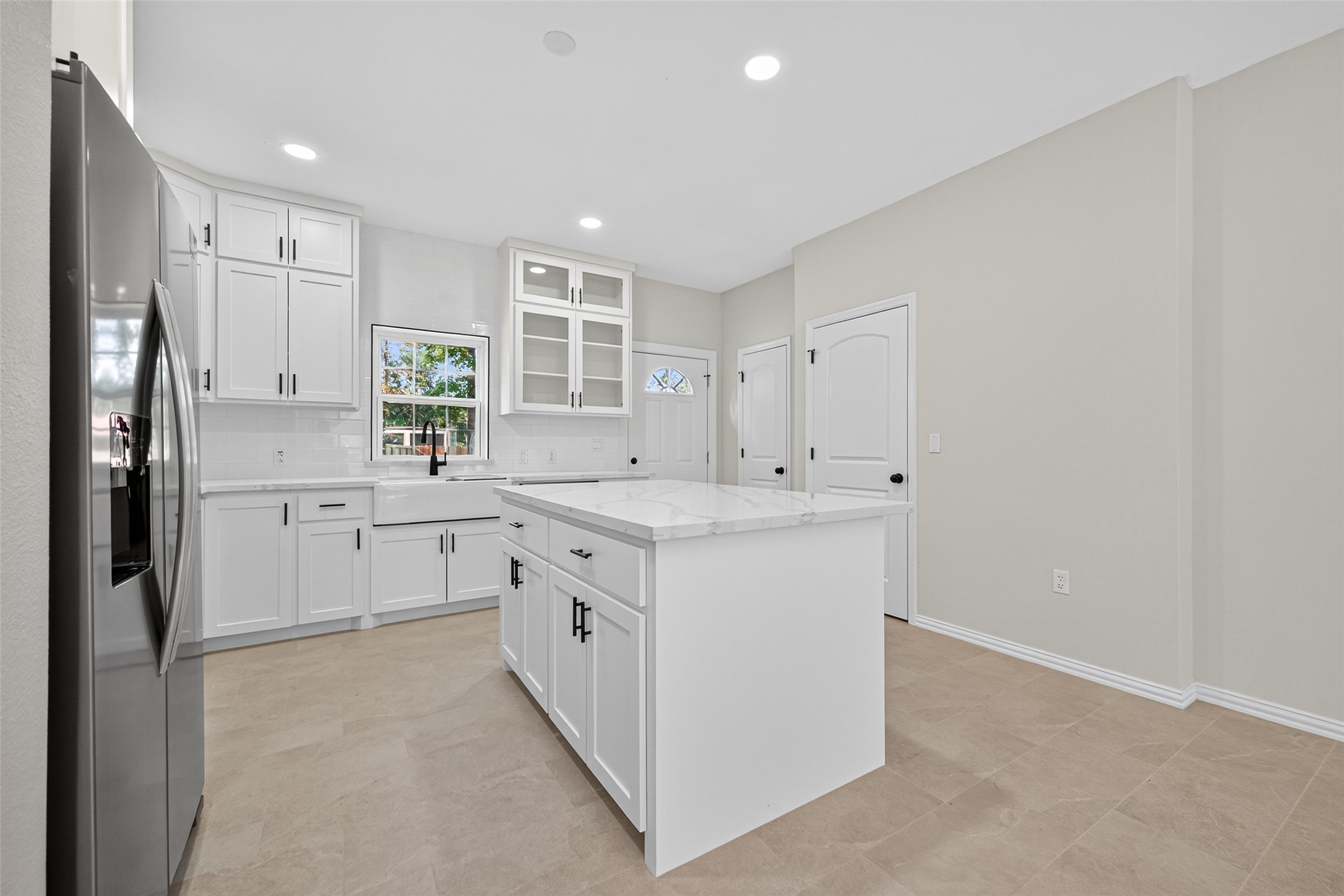 10594 Rustling Oaks Drive Conroe, TX 77303 - Photo 11 of 40 a kitchen with white cabinets and white appliances