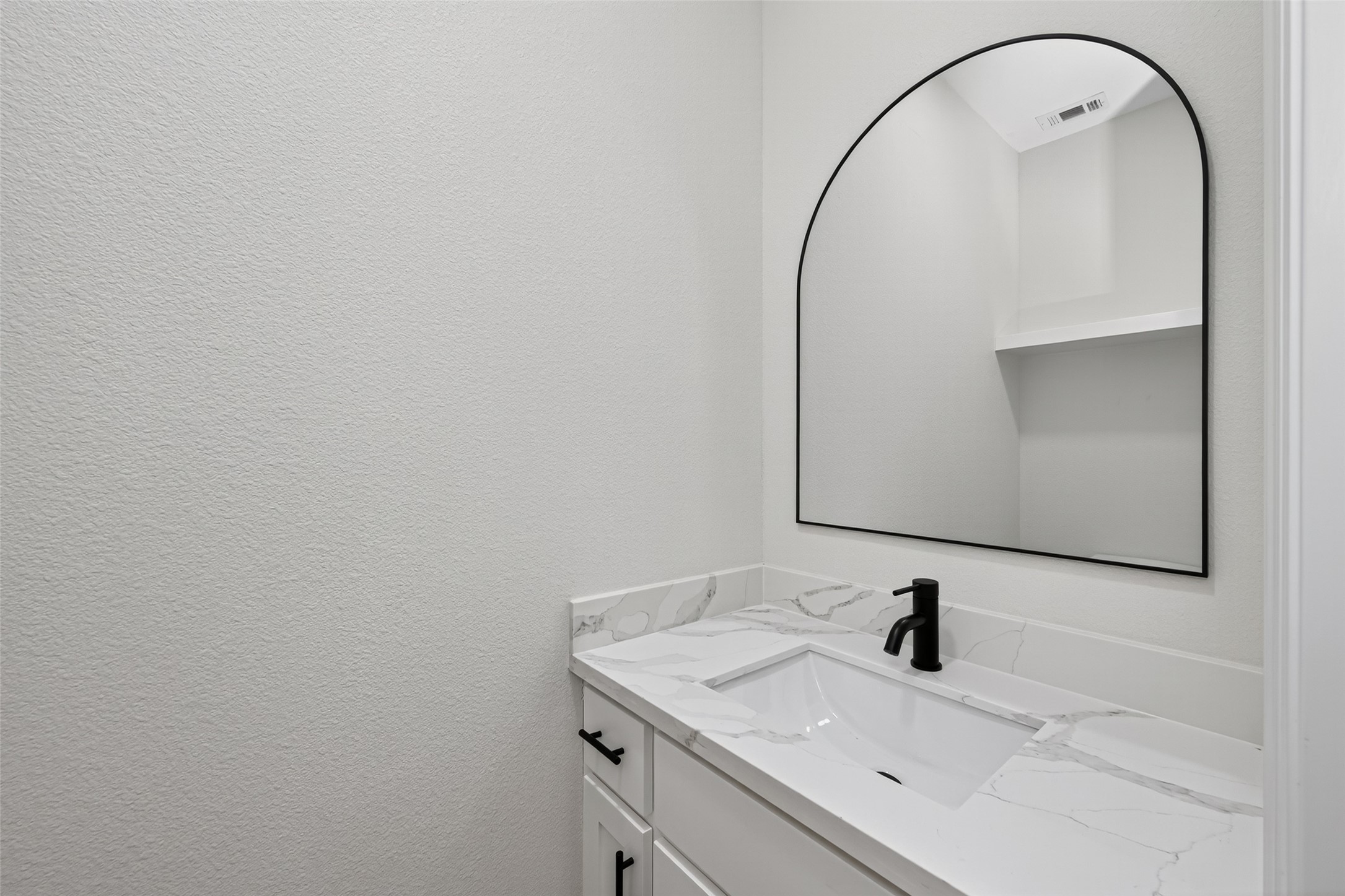 10594 Rustling Oaks Drive Conroe, TX 77303 - Photo 12 of 40 a bathroom with a sink and a mirror