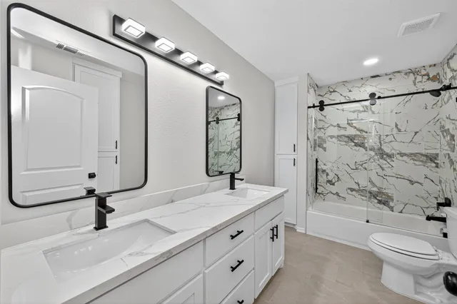 a bathroom with 2 sink tub and a mirror