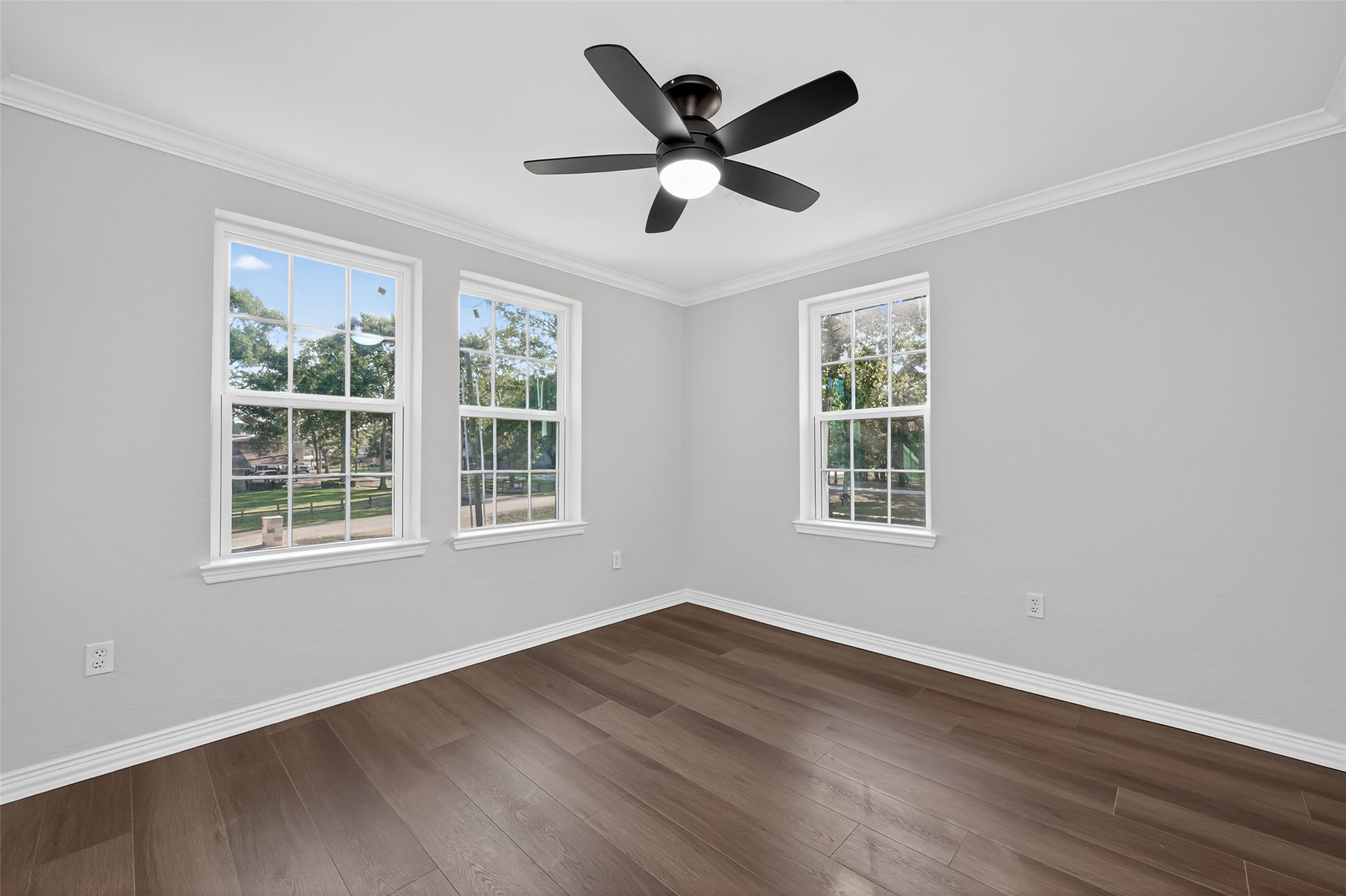 10594 Rustling Oaks Drive Conroe, TX 77303 - Photo 24 of 40 a view of empty room with wooden floor and ceiling fan