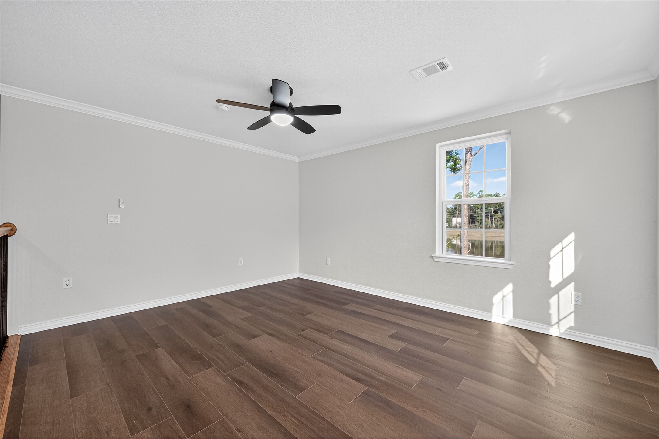10594 Rustling Oaks Drive Conroe, TX 77303 - Photo 27 of 40 a view of empty room with wooden floor and fan