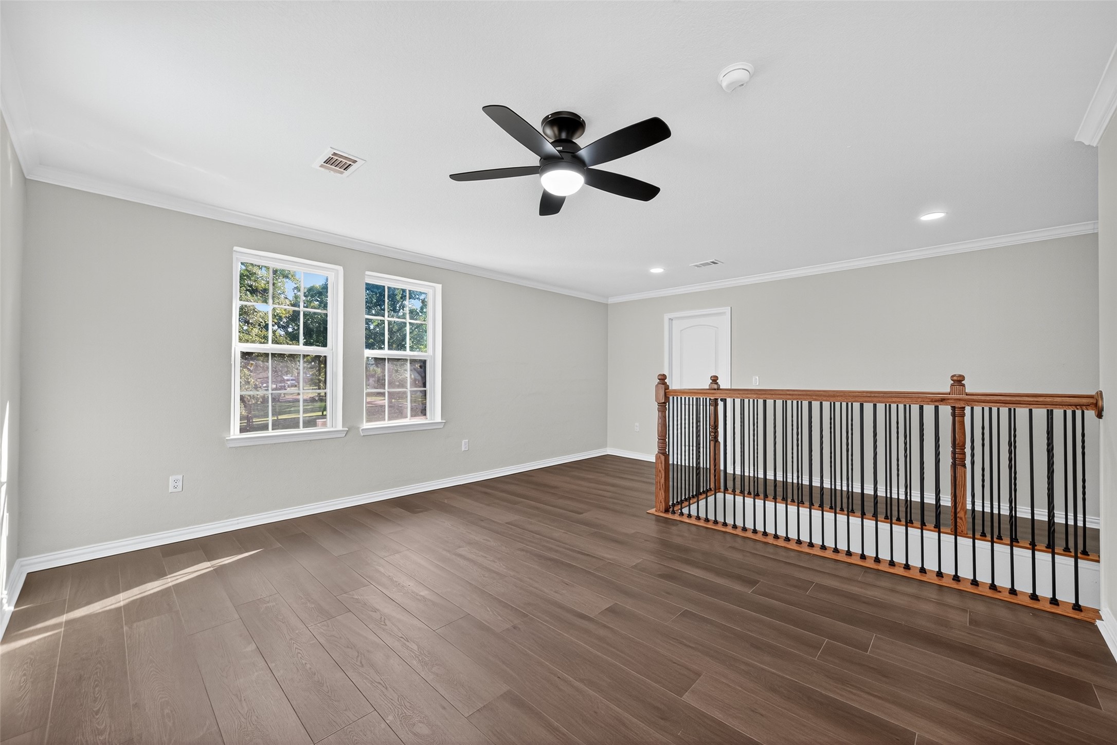 10594 Rustling Oaks Drive Conroe, TX 77303 - Photo 29 of 40 a view of an empty room with wooden floor and a window