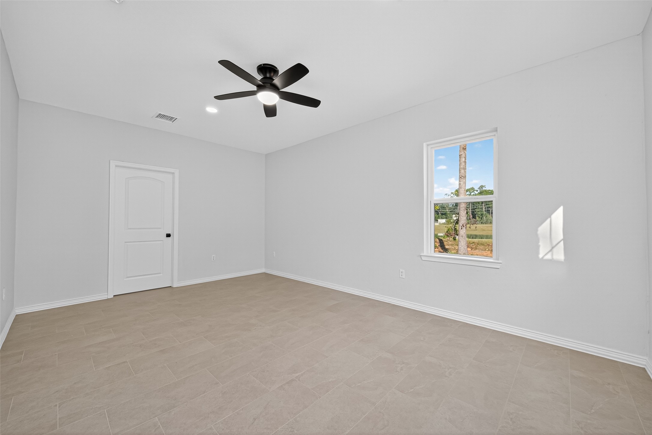 10594 Rustling Oaks Drive Conroe, TX 77303 - Photo 30 of 40 a view of an empty room with a window