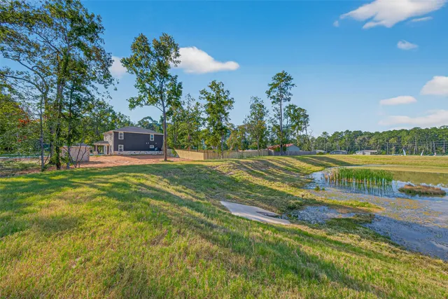 a view of a lake with houses in the back