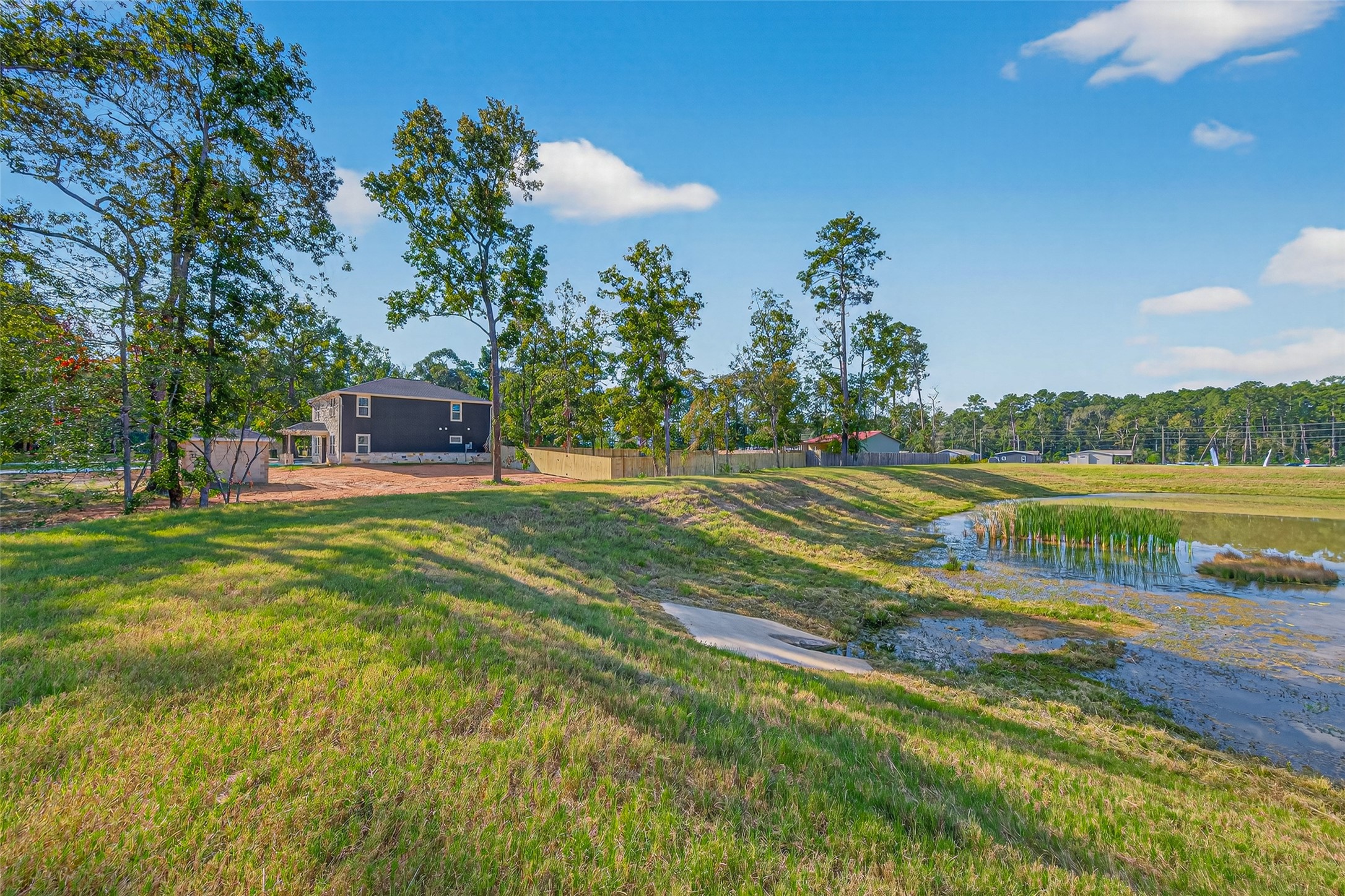 10594 Rustling Oaks Drive Conroe, TX 77303 - Photo 39 of 40 a view of a house with a big yard