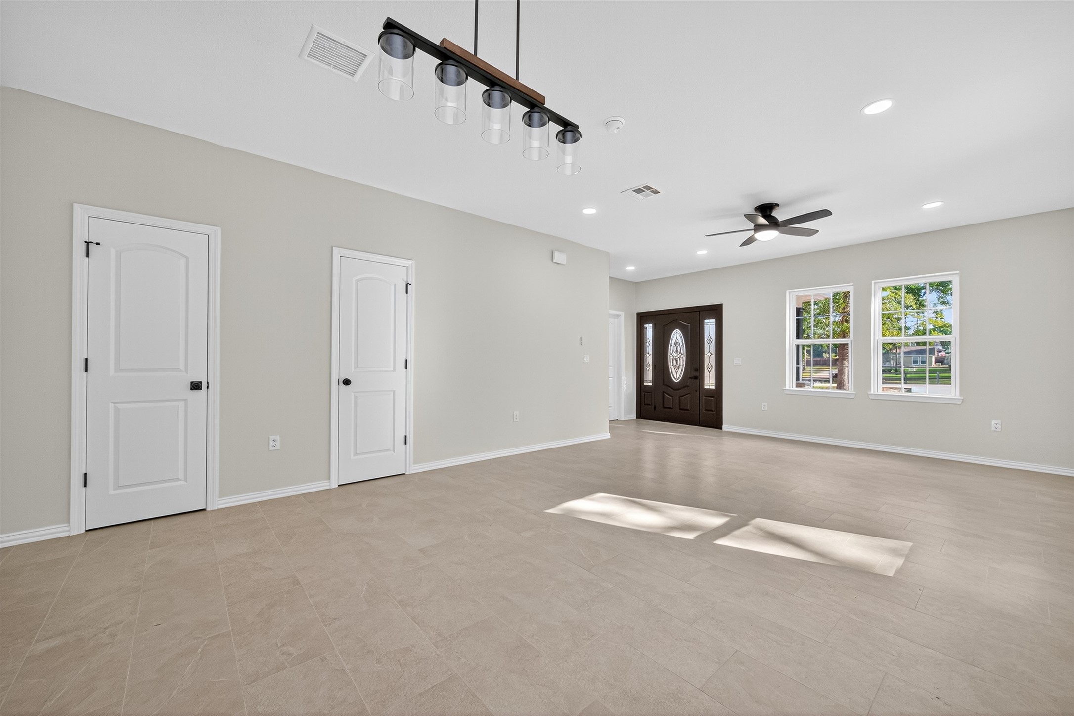 10594 Rustling Oaks Drive Conroe, TX 77303 - Photo 4 of 40 a view of an empty room with a window and fireplace
