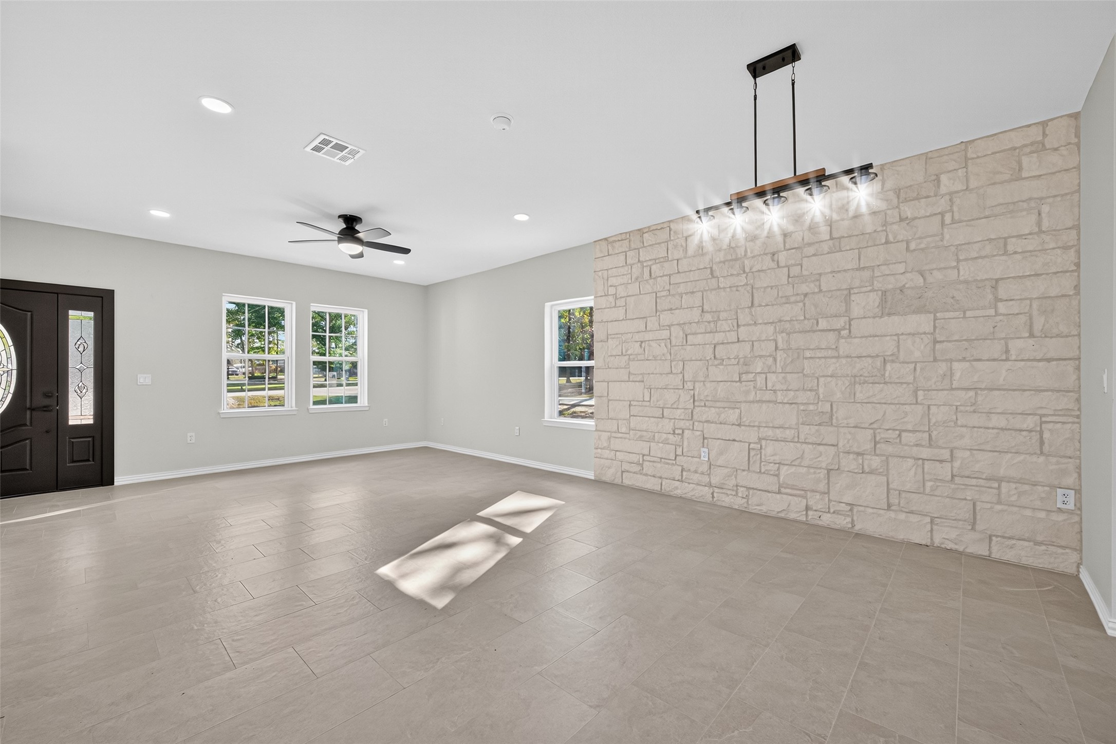 10594 Rustling Oaks Drive Conroe, TX 77303 - Photo 7 of 40 a view of an empty room with a window