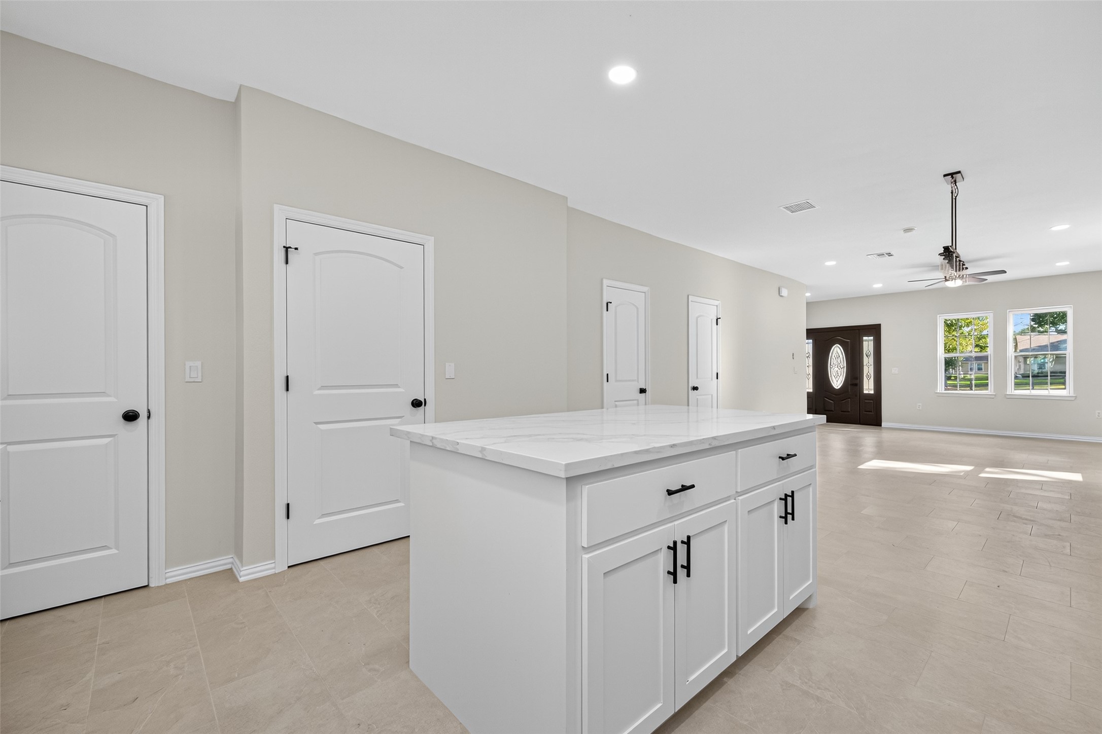 10594 Rustling Oaks Drive Conroe, TX 77303 - Photo 9 of 40 a kitchen with white cabinets and sink