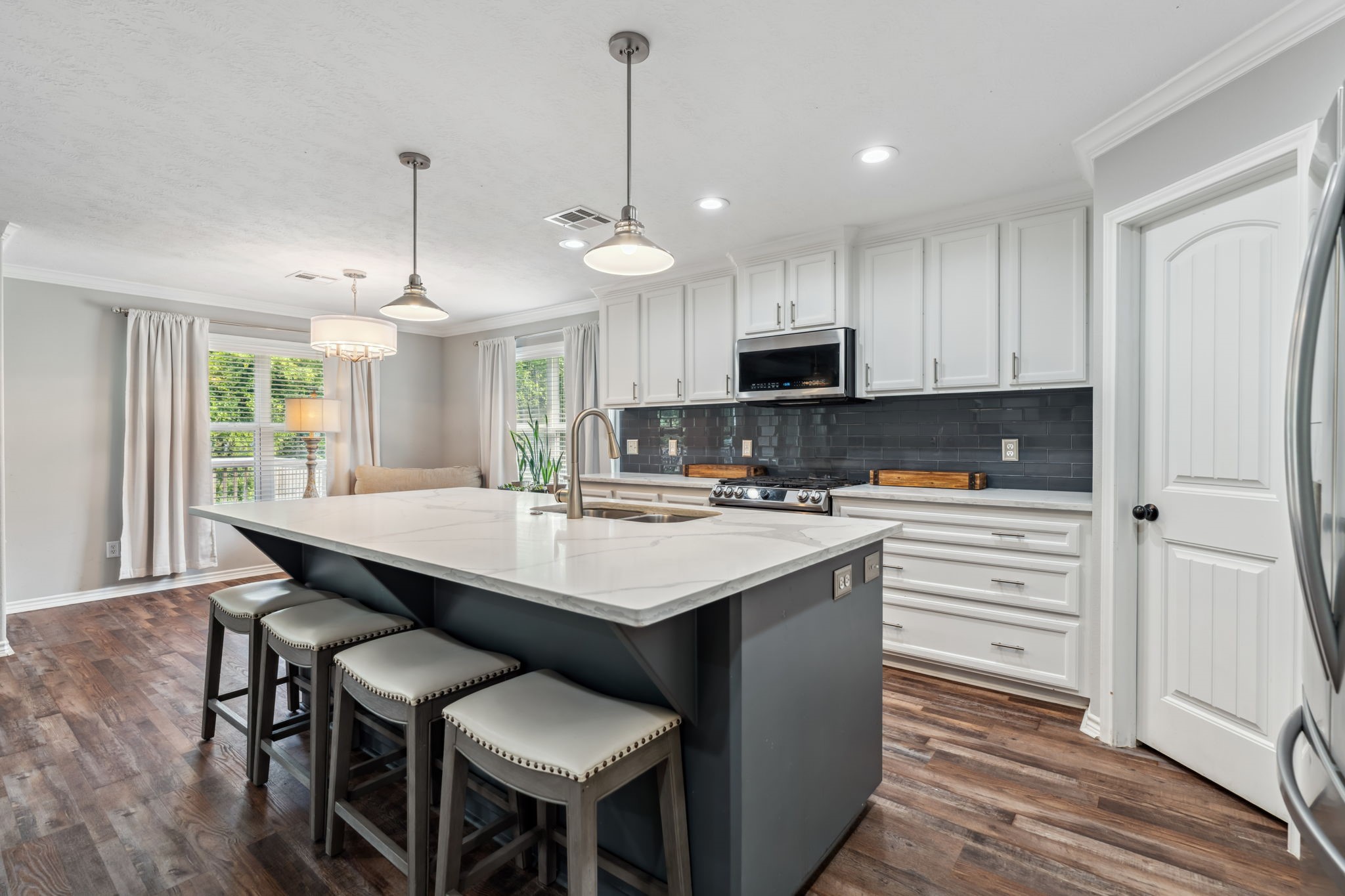 129 Bridgepoint Onalaska, TX 77360 - Photo 8 of 35 a kitchen with kitchen island granite countertop a sink a center island and appliances