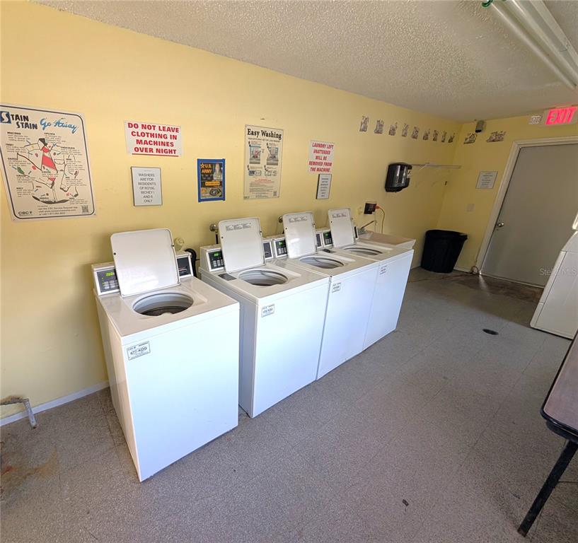 5521 Bay Boulevard, Unit 201 Port Richey, FL 34668 - Photo 12 of 12 a kitchen with cabinets a sink and a stove top oven