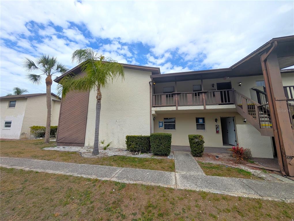 5521 Bay Boulevard, Unit 201 Port Richey, FL 34668 - Photo 2 of 12 a front view of a house with a yard