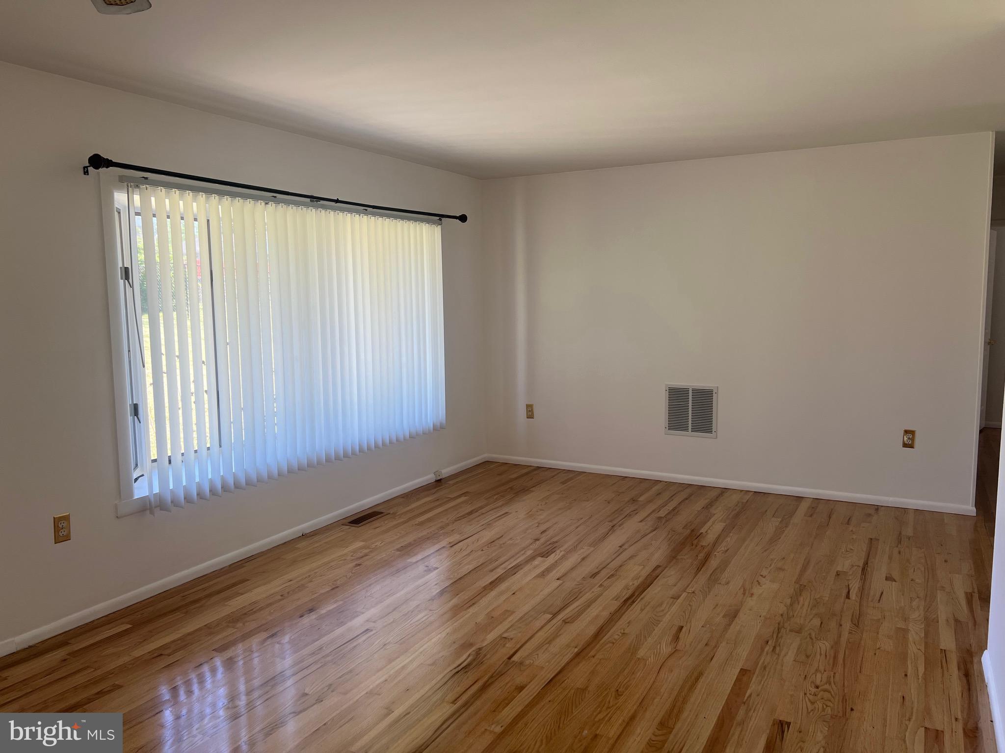 705 Bayberry Road Edgewood, MD 21040 - Photo 10 of 28 an empty room with wooden floor and windows