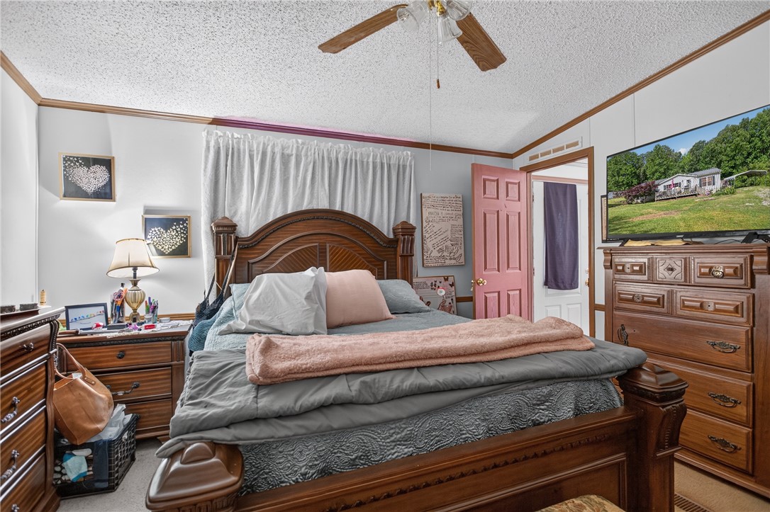 418 Chauga Road Westminster, SC 29693 - Photo 14 of 38 A comforting bedroom with a classic wooden bed frame, offering a peaceful retreat.