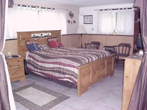 1915 East Clark Street Diamond, IL 60416 - Photo 8 of 14 a bedroom with a bed and a window