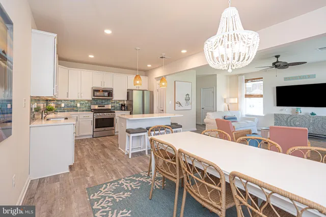 a large kitchen with a table and chairs
