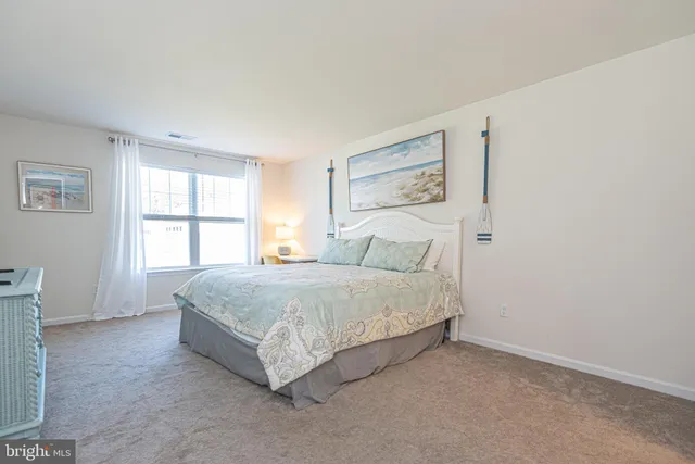 a spacious bedroom with a bed and a window