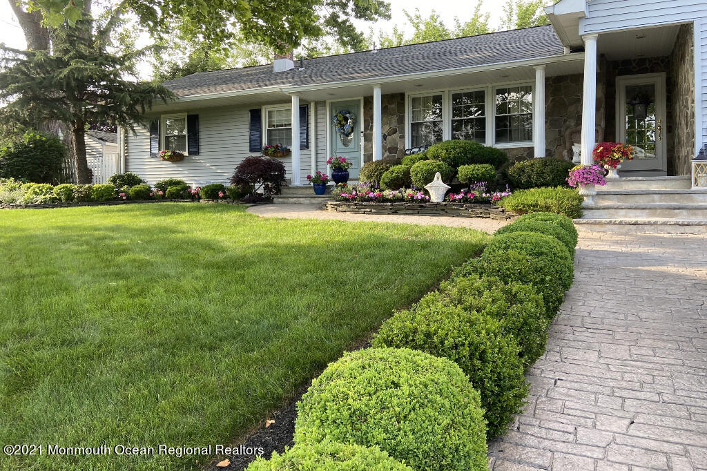 1132 Mohegan Road Manasquan, NJ 08736 - Photo 1 of 35 a front view of a house with a yard and porch