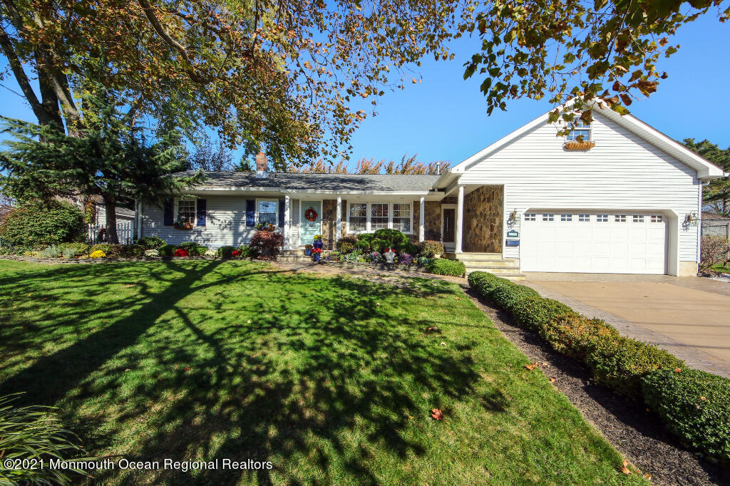 1132 Mohegan Road Manasquan, NJ 08736 - Photo 2 of 35 a front view of a house with garden