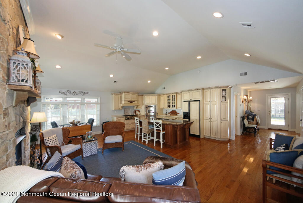 1132 Mohegan Road Manasquan, NJ 08736 - Photo 16 of 35 a living room with lots of furniture and kitchen view