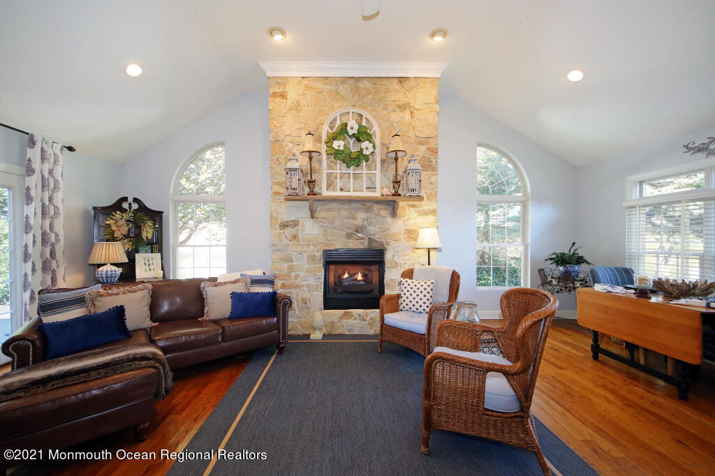 1132 Mohegan Road Manasquan, NJ 08736 - Photo 22 of 35 a living room with furniture and a fireplace