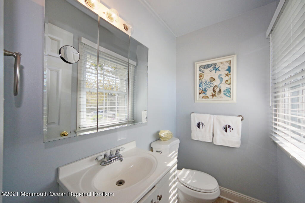 1132 Mohegan Road Manasquan, NJ 08736 - Photo 27 of 35 a bathroom with a sink a toilet and a window