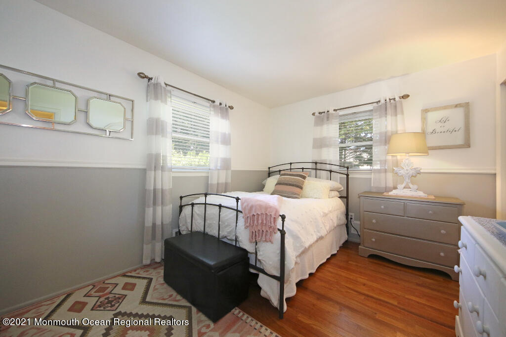 1132 Mohegan Road Manasquan, NJ 08736 - Photo 28 of 35 a bedroom with a bed and wooden floor
