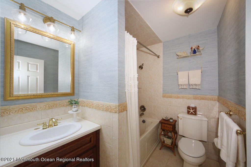 1132 Mohegan Road Manasquan, NJ 08736 - Photo 30 of 35 a bathroom with a sink toilet and mirror