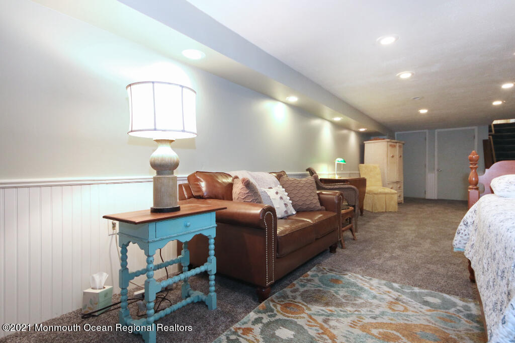 1132 Mohegan Road Manasquan, NJ 08736 - Photo 31 of 35 a living room with furniture and a lamp
