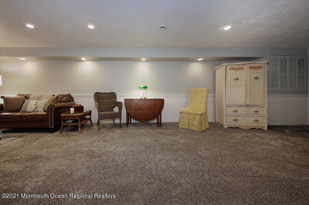 1132 Mohegan Road Manasquan, NJ 08736 - Photo 32 of 35 a living room with furniture and a dresser