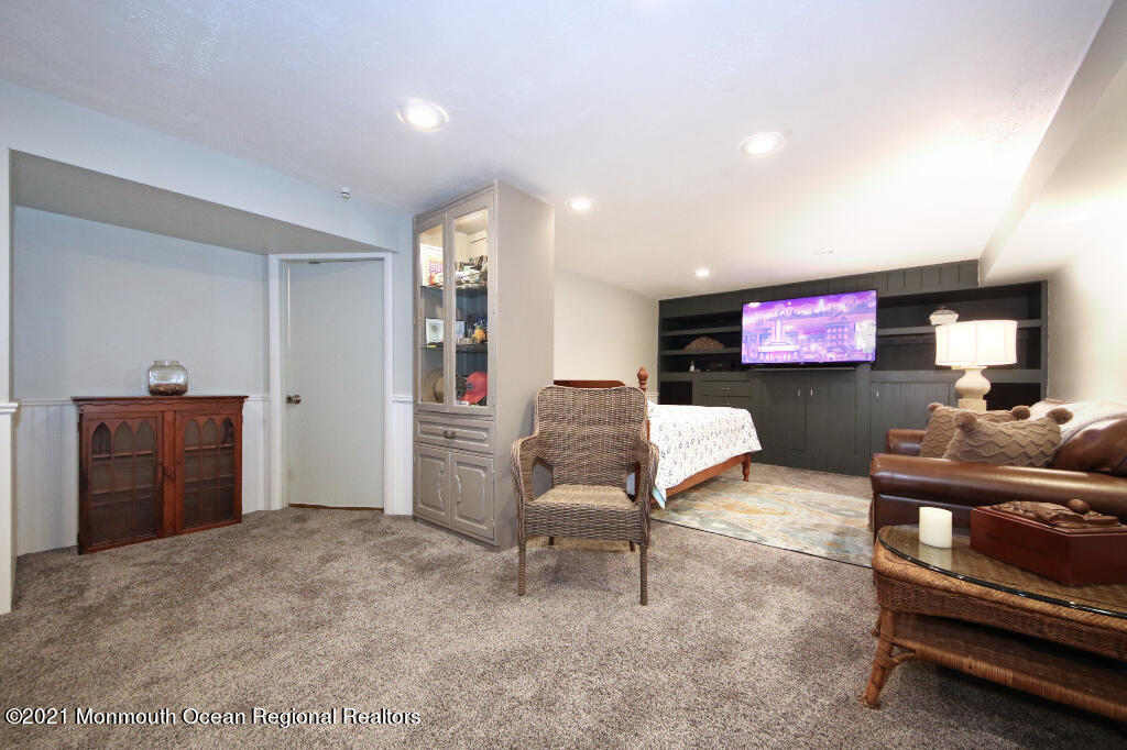 1132 Mohegan Road Manasquan, NJ 08736 - Photo 33 of 35 a living room with furniture and a flat screen tv