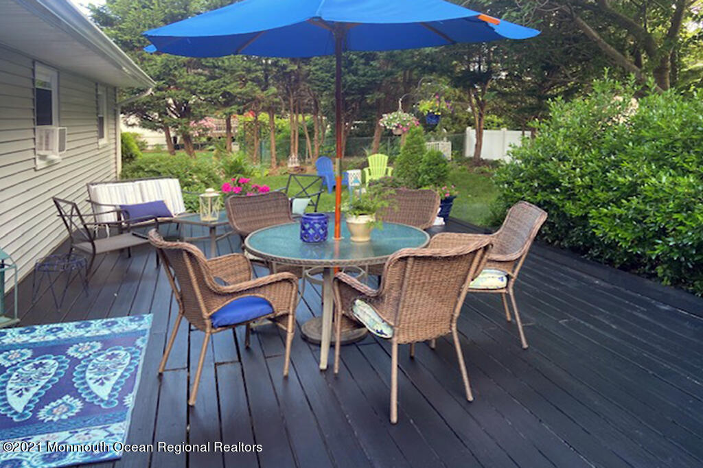 1132 Mohegan Road Manasquan, NJ 08736 - Photo 10 of 35 a view of a patio with a table and chairs under an umbrella