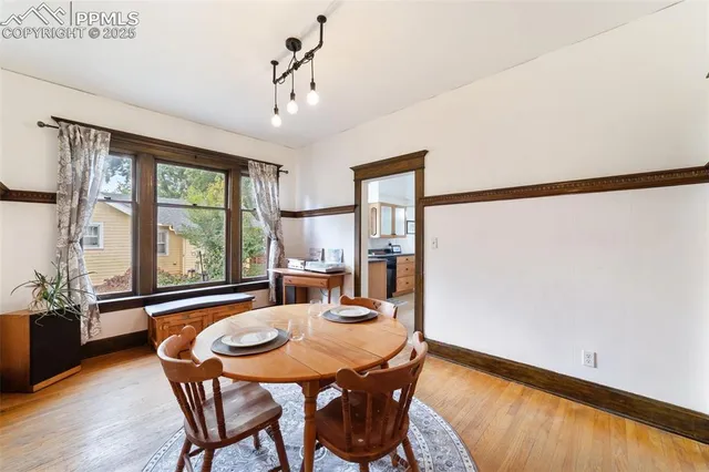 a view of a dining room with furniture window and wooden floor