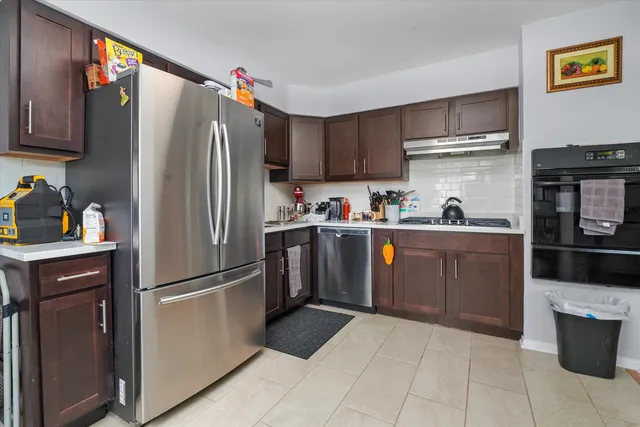 a kitchen with stainless steel appliances a refrigerator sink and cabinets