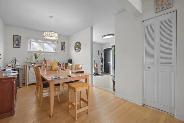 a view of a a dining room with furniture window and wooden floor