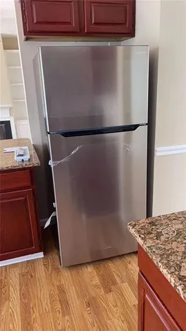 a view of a storage and utility room with wooden floor