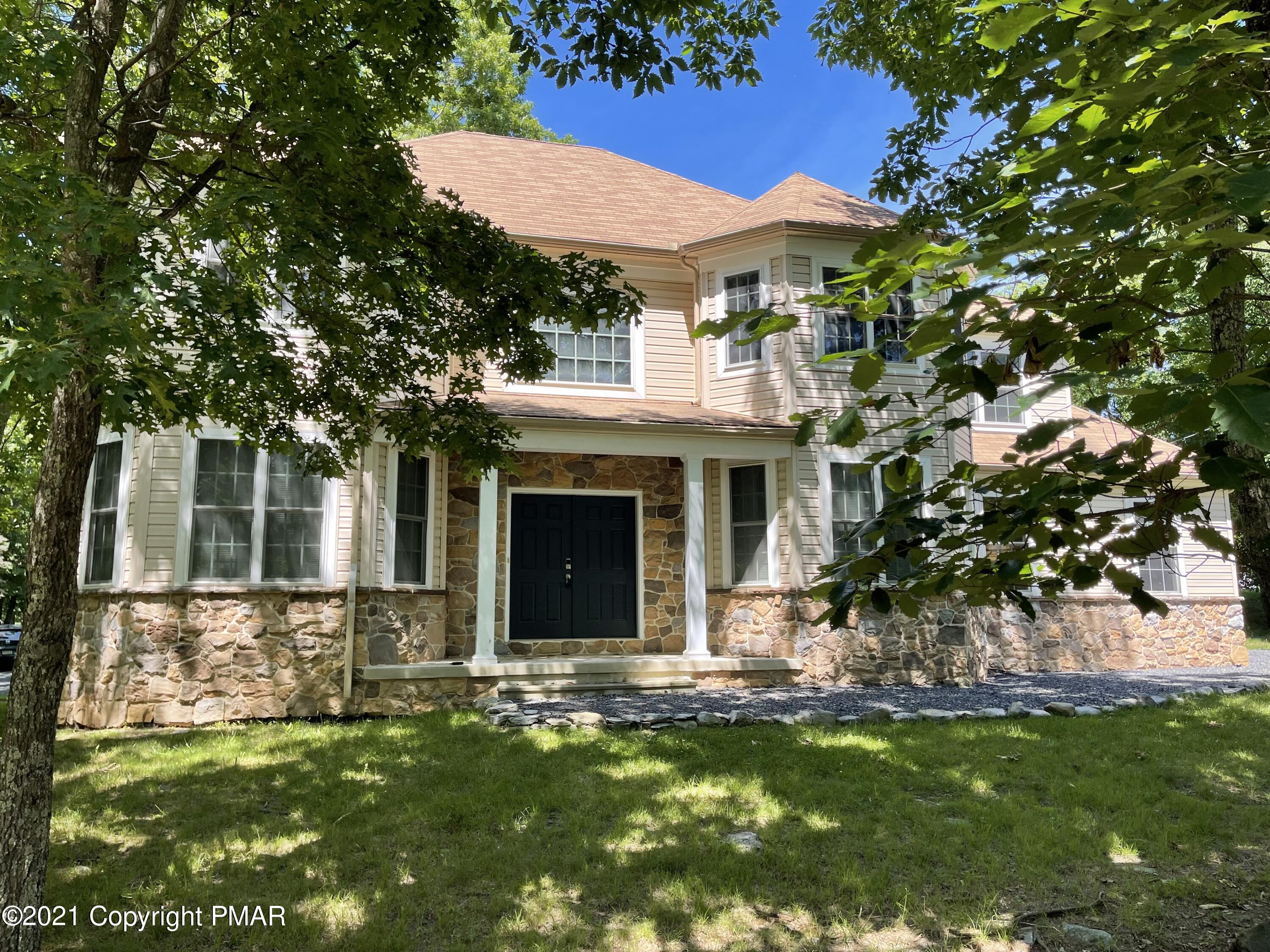136 Pike Road Bushkill, PA 18324 - Photo 1 of 35 a front view of a house with a garden