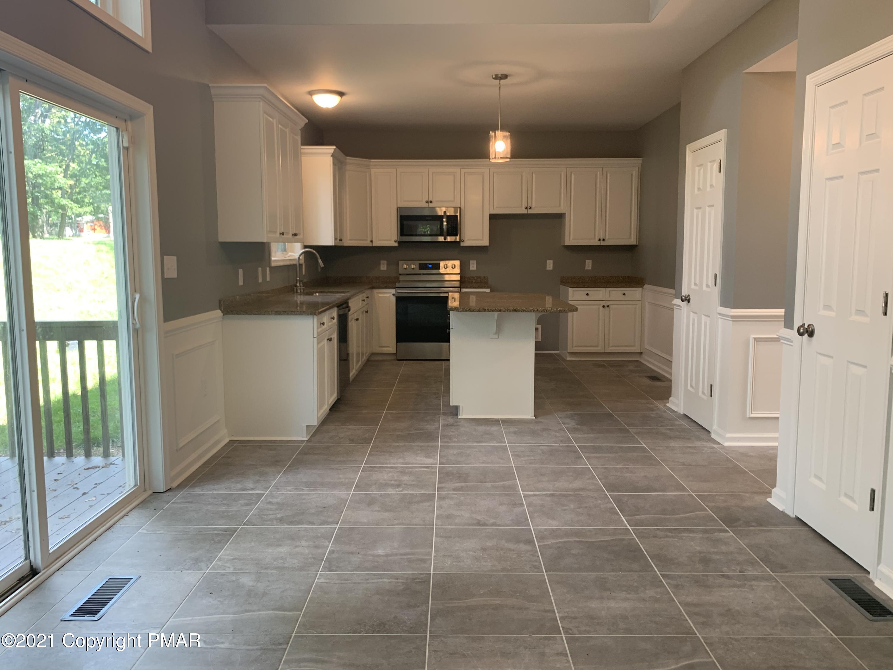 136 Pike Road Bushkill, PA 18324 - Photo 11 of 35 a kitchen with a sink a counter top space cabinets and stainless steel appliances