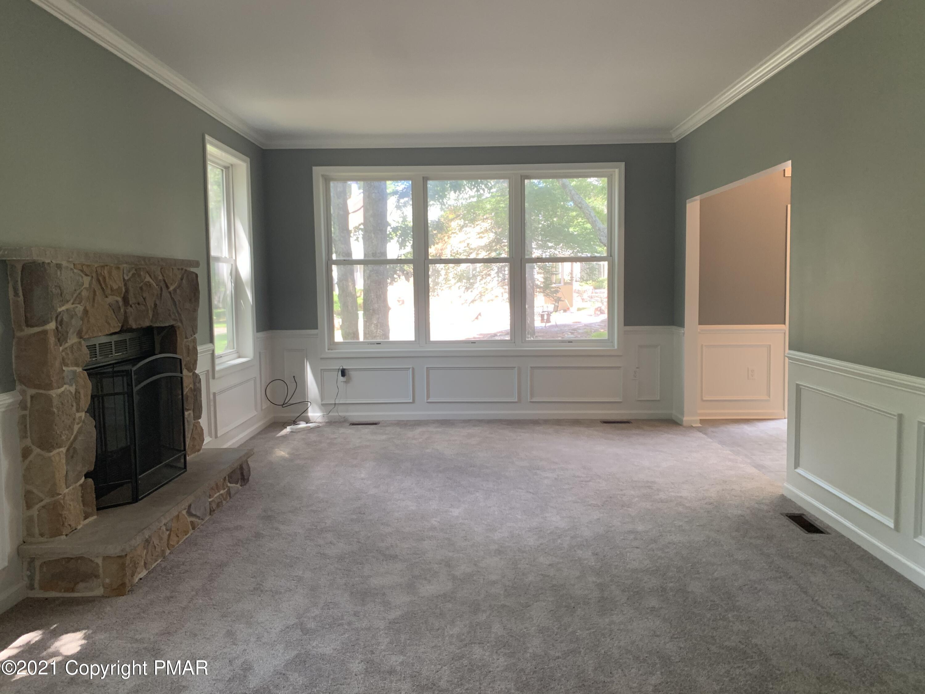 136 Pike Road Bushkill, PA 18324 - Photo 8 of 35 a view of an empty room with a fireplace and a window