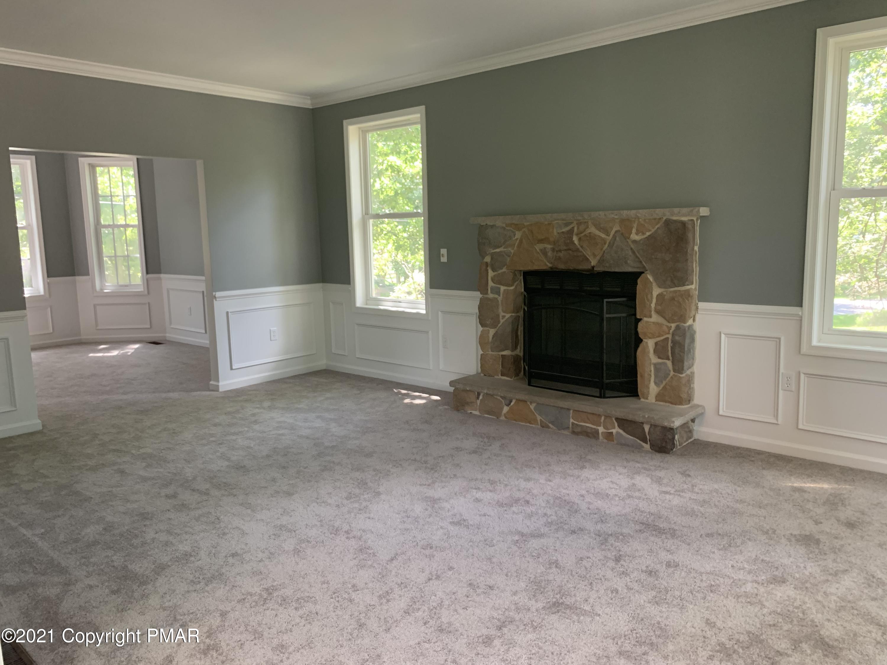 136 Pike Road Bushkill, PA 18324 - Photo 10 of 35 an empty room with windows and fireplace