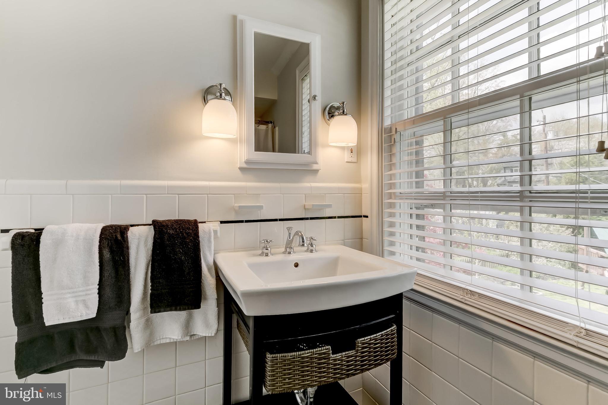 322 Broadmoor Road Baltimore, MD 21212 - Photo 23 of 49 Newish sink, mirror and lighting in the hall bath.