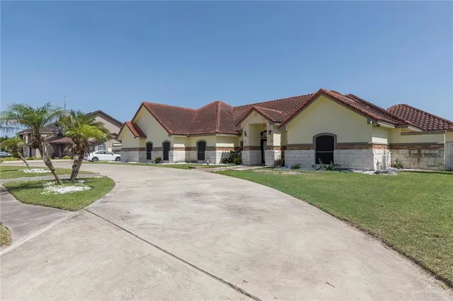 a front view of house with yard and green space