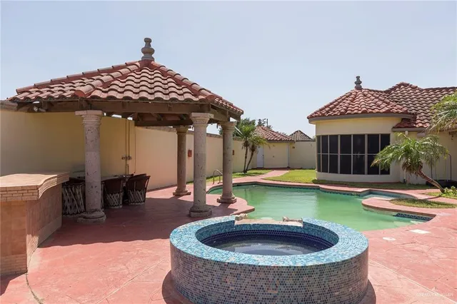 a view of a house with swimming pool and sitting area