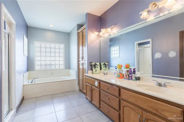 a bathroom with a tub sink and mirror