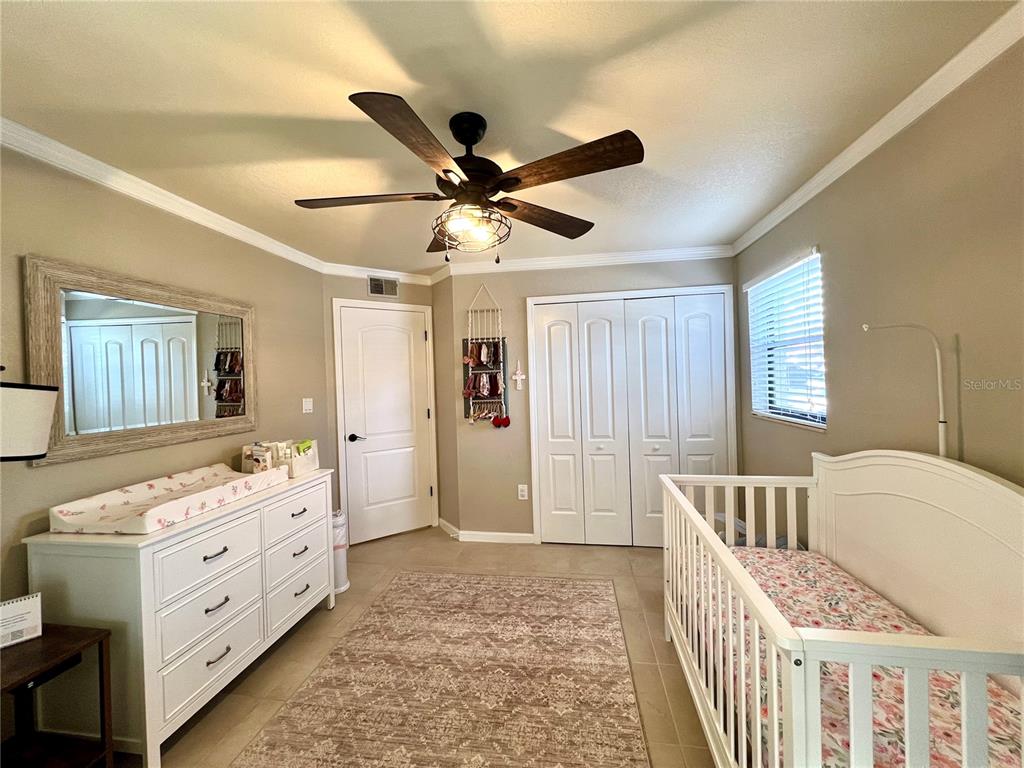 2101 Hammock Pine Boulevard, Unit 2101 Clearwater, FL 33761 - Photo 11 of 24 a bedroom with furniture and a window